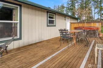 The deck with hot tub, the door leads to the utility room adjacent to the kitchen.