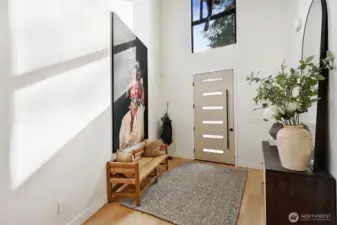 Enter the foyer on the ground level and the attached garage is to the right in this photo.