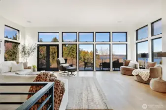 Upper living area where lake, light, and living spaces blend. The deck faces north.
