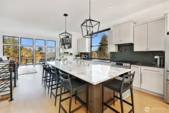 Gather around the 5-seating island or congregate in the dining room to the right of his photo.