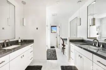 Primary bathroom with water closet and walk in shower.  Double floating vanities with toekick lighting.