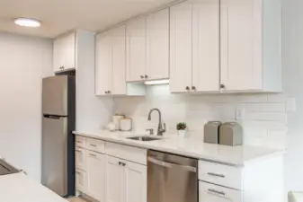 Upgraded kitchen with newer cabinets, Quartz countertops, and stainless steel appliances