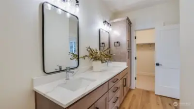 A linen closet and a generously sized walk-in closet adjoin the primary bathroom.