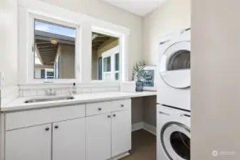 Spacious laundry room with stacked washer & dryer.