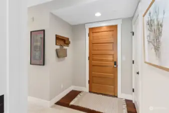 Convenient entry space with coat closet and coat hooks.