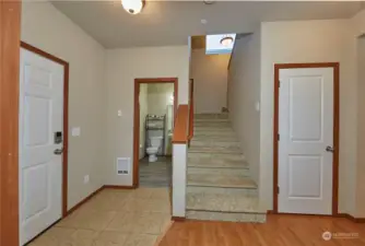 Powder room off of entry way opposite the den.