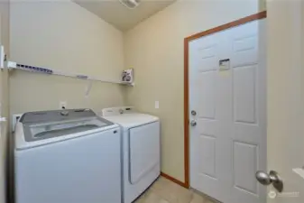 Laundry room off kitchen leading to garage.