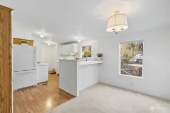 Dining room area with additional kitchen seating at the counter.