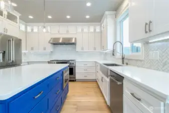 Custom cabinetry with soft close feature provides ample storage throughout.