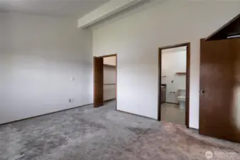 Upstairs primary bedroom looking toward closet and bath.