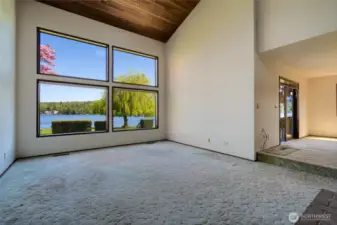 Soaring vaulted wood ceilings and breathtaking lake views from this wonderful living space.