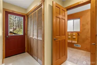 Utility room with washer, dryer, sink, and storage
