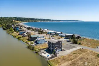 Waterfront home near beach - showing Admirals Cove Clubhouse & Pool in upper left corner and vacant lot to the W of the home.
