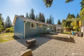 Gather with friends and family around a fire in this inviting side yard.
