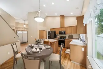 Kitchen w/view of entryway and opening to dining room. (Virtually Staged)