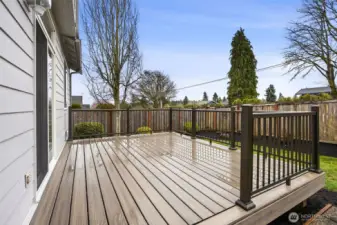 The backyard features a low-maintenance newer Trex deck, making cleaning and upkeep easy and stress-free.