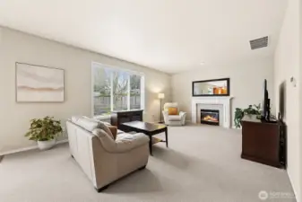 Spacious family room offers lots of seating options & cozy gas fireplace with mantle.