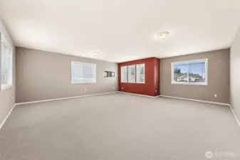 Massive bonus/media room. The FOUR wood wrapped windows offer light to flood this room.