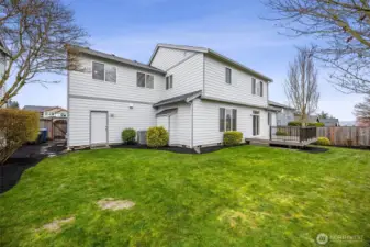 A gate leads to the front yard, offering easy access while maintaining a functional and well-designed outdoor space. Heat pump for this home is nicely tucked away in the corner.