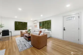 Bright and open main living space surround by trees accentuated by fully fenced yard.