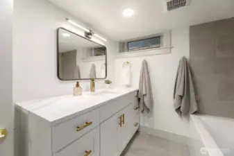 Lower level bathroom with non-conforming ceiling heights offers additional bathroom.