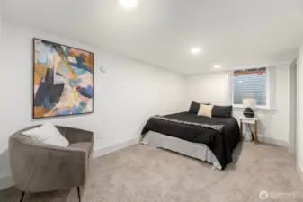 Lower level bedroom with non conforming ceiling heights offers egress, full closet and storage.