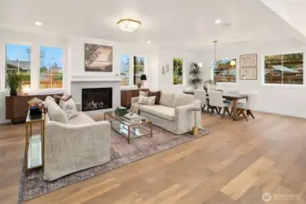 Stylish details include handsome fireplace flanked by symmetrical windows