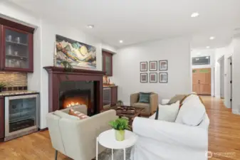 Family room boasts warm custom cabinetry and two built-in beverage and wine fridges.