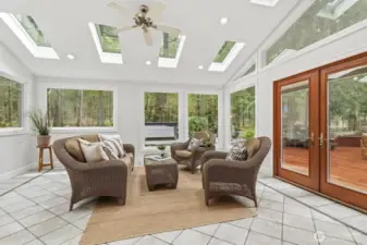 A rare and beautiful 300 sq ft sunroom with custom tile, heated floors and skylights, perfect for enjoying natural light year-round.