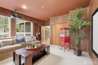 Theater setup with blackout curtains, screen, projector, and electronics—all included for memorable movie nights.