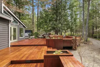 Deck thoughtfully designed with built-in seating, bar, and planter boxes.