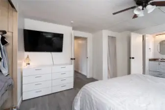 Another view of the expansive primary bedroom showcasing ample wall space, modern finishes, and easy flow to adjoining rooms, including the ensuite bath.