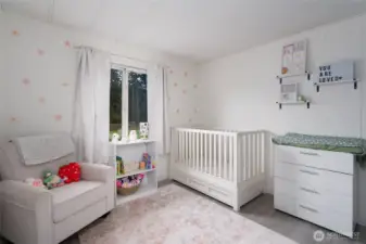 Charming nursery or bedroom with soft natural light, neutral color palette, and cozy finishes. Perfect as a baby room, guest space, or home office.