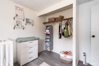 Functional closet space within the nursery featuring hanging storage and shelving, ideal for organizing clothing, toys, and essentials.