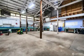 Expansive shop or garage with high ceilings, workbenches, and loft storage. This versatile space is perfect for hobbies, equipment storage, or a home-based business, offering endless possibilities for customization.