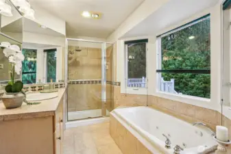 Soak away your troubles in the tub and put on a fresh face for every day in this delightful ensuite.