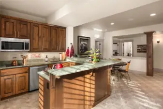 The lower level's second kitchen features microwave, electric cooktop, dishwasher and mini fridge.