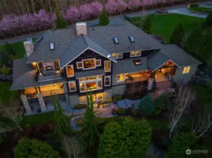 Exterior spaces include Mt. Baker view deck off master with propane fireplace, wrap around covered porch on main, intimate covered porch with vault and skylight off kitchen on main, covered patio on lower and uncovered patio on lower featuring bespoke hard-scaped fire pit.