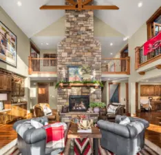 The two-story, stacked-stone, propane fireplace with hearth is the heart of this home.  Bespoke cabinetry offers lit display shelving, under cabinet lighting, stab granite counters and craftsman crown detail.