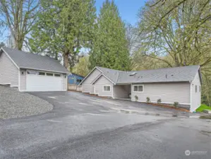 Renovated rambler, detached two car garage, and expansive parking area including a designated RV parking