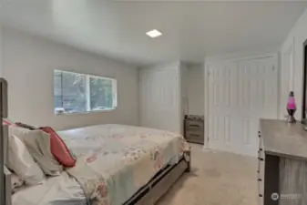 Primary bedroom with dual closets and it's own bathroom