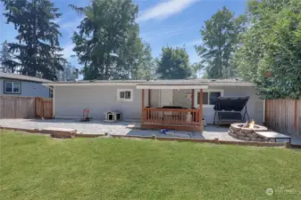 view of the back and the covered deck and firepit area