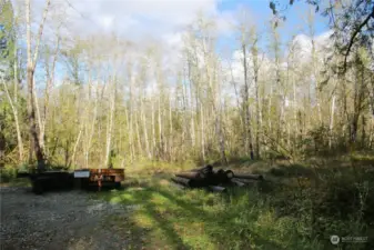 Clearing area at the back of the property to accommodate the septic drainfield. There are sewer pipes already installed that will carry the wastewater from the front to the back here.