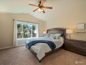 Primary bedroom with vaulted ceilings