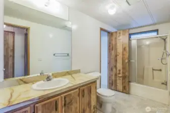 Full bath with two entrances and a clerestory window above the tub and shower.