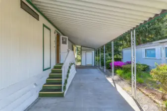 At the end of the carport sits the paint matching secured storage shed.