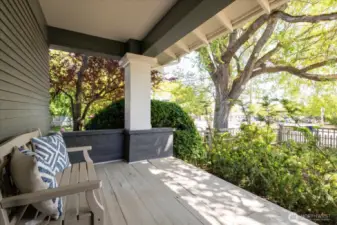 Covered porch invites  you to sit and watch the world go by....