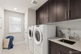 Laundry room connects to primary suite. For representation purposes only colors may vary.