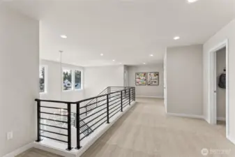 Upstairs landing/hall with modern railing and open spaces bring in lots of light!