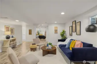 Large lower level great room can be used in many ways. Virtually staged here as an additional living room.
